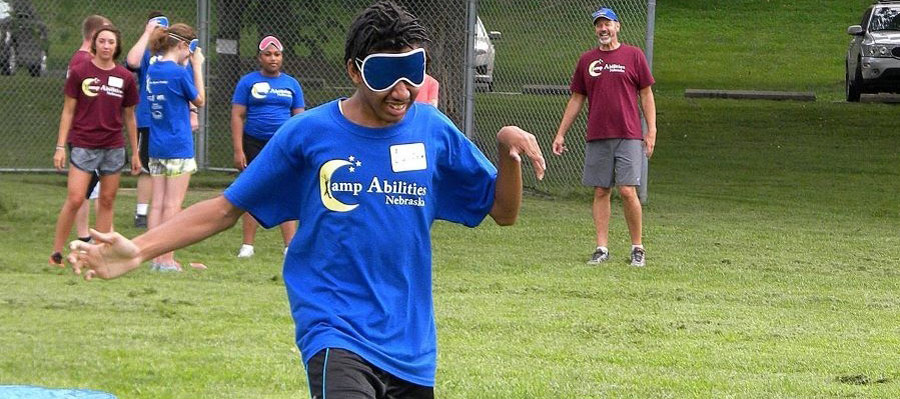 Camp Abilities Nebraska Recreation Day - Young man playing beeping baseball