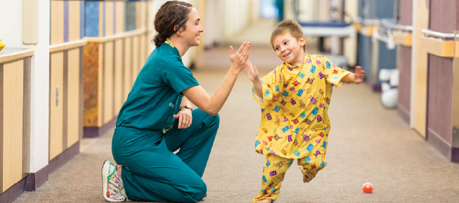 Dr. Fornoff high fiving a running child