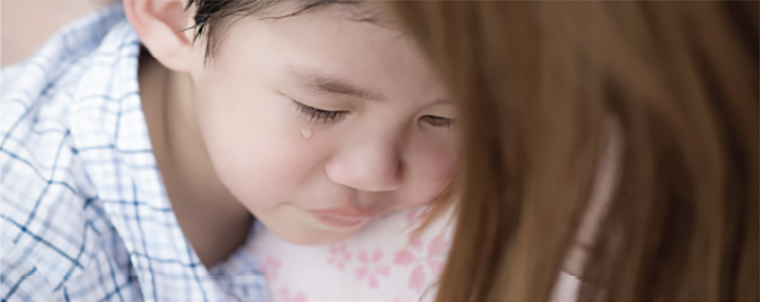 Child crying in moms arms