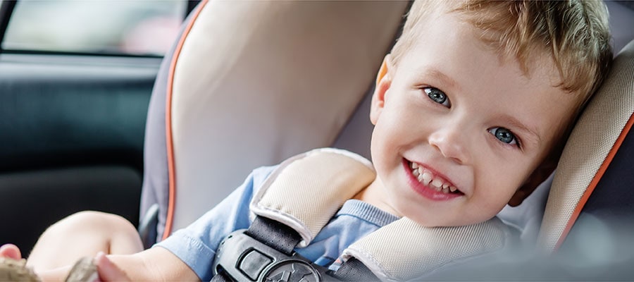 Toddler Boy Smiling in Car Seat