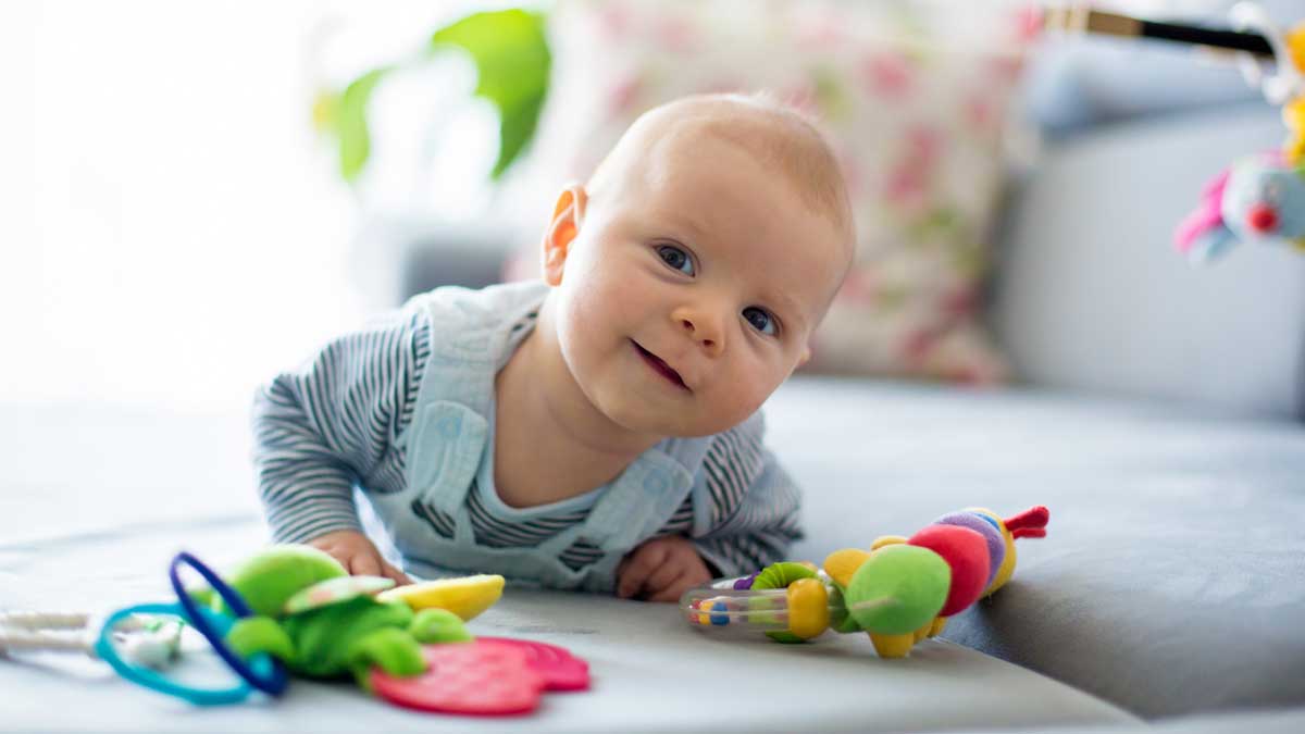 baby doing tummy time with colorful toys
