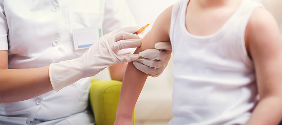 Boy getting vaccination in upper arm