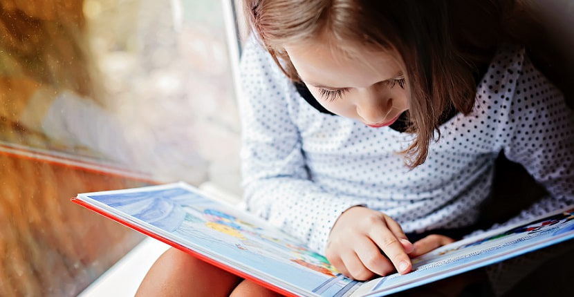 young girl reading book