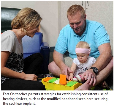 Child with hearing aid participates in research study